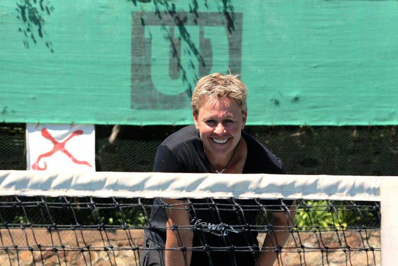 Anita looking over the net at the camera.