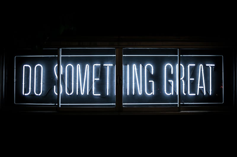 A neon sign that says, "do something great".