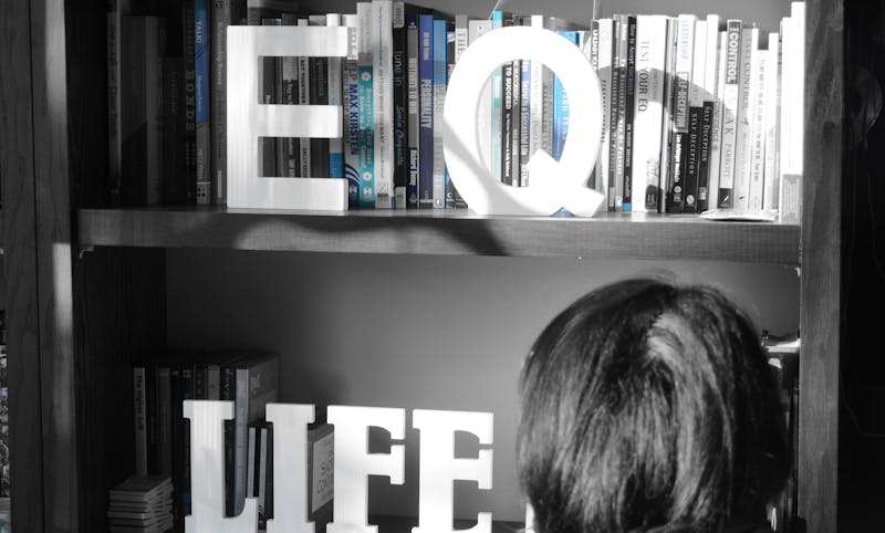 Anita's life coaching room. Picture is in black and white with the letters "EQ" and "LIFE" on shelf.