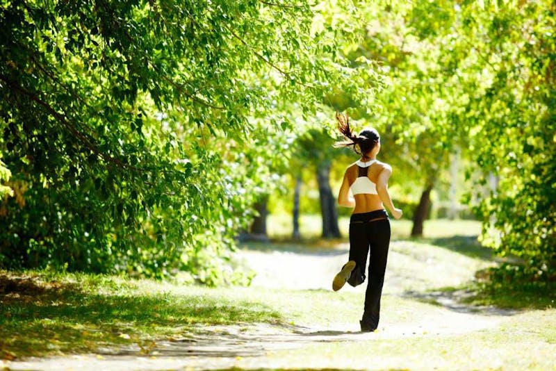 Girl running in a park.