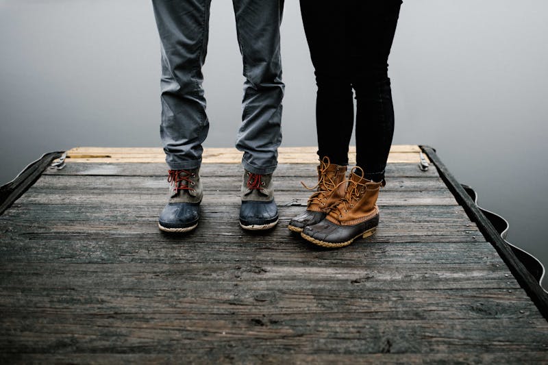 Two people on jetty - legs only.