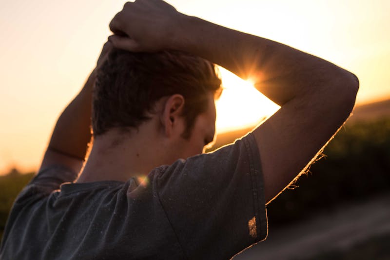 A guy with his hands on his head.