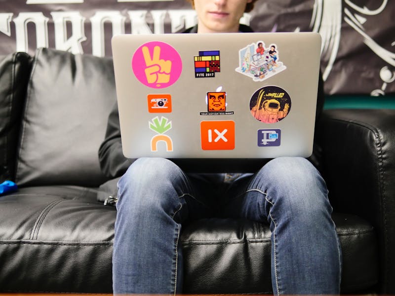 Laptop with lots of stickers on it.