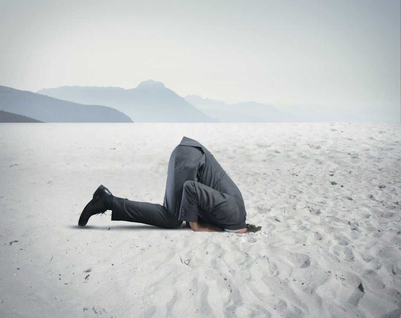 Man with head in the sand.