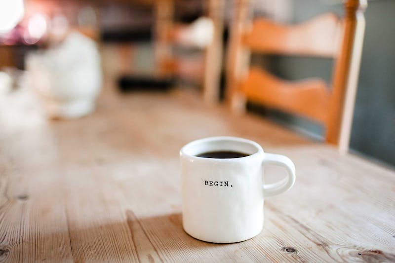 A mug with the words "Begin." written on it.