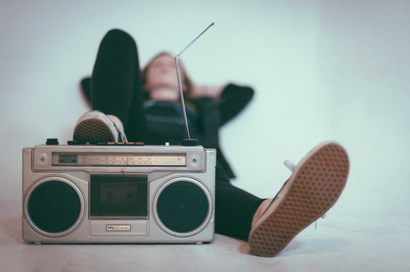 Old radio with someone's foot on top of it.