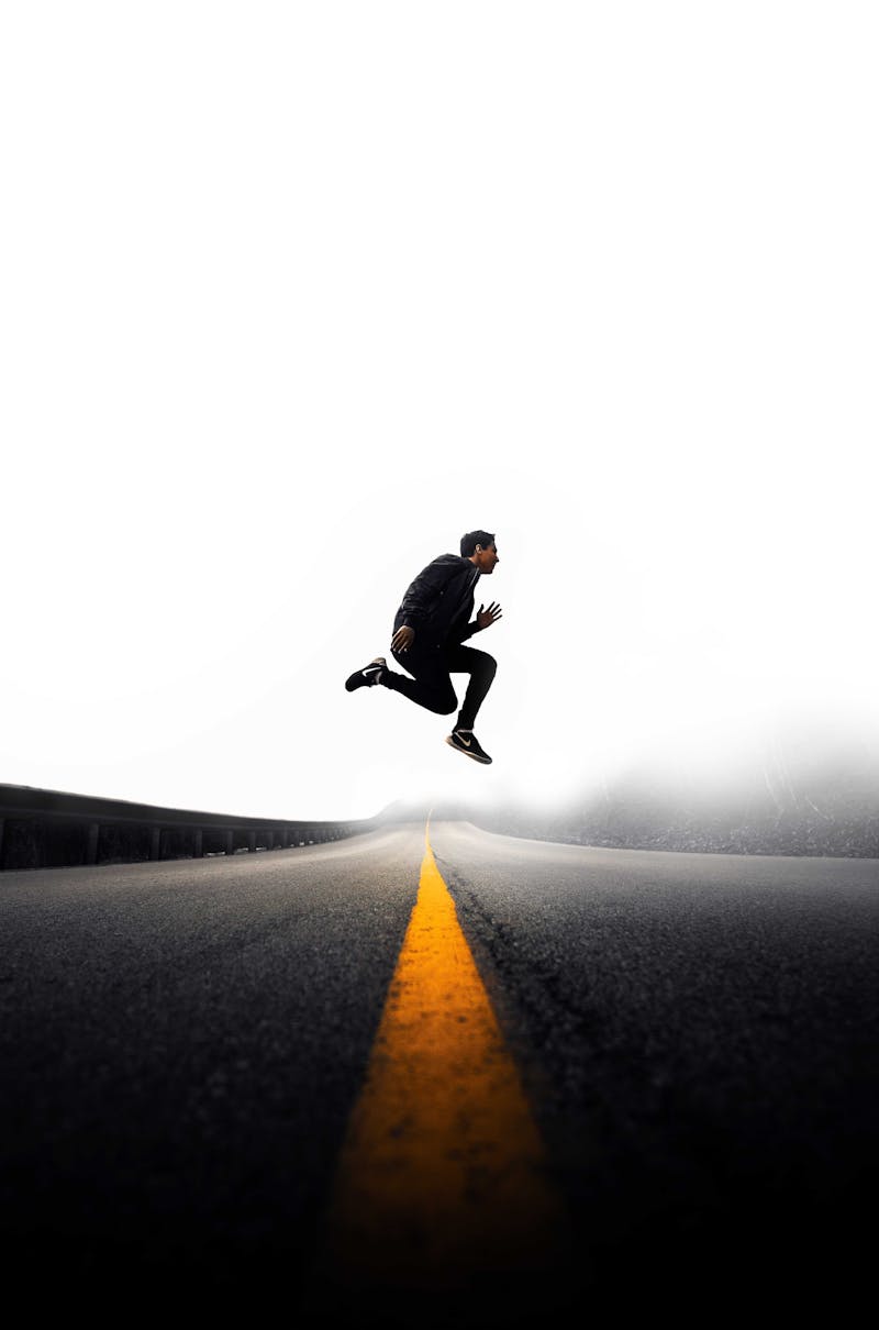 Guy jumping on road.