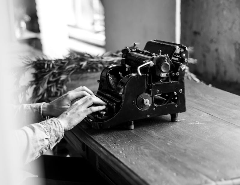 Someone writing on a typewriter.