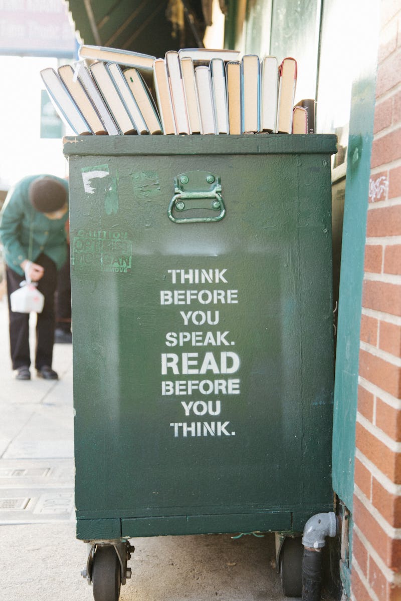 Text on a big container of some sorts that reads, "THINK BEFORE YOU SPEAK. READ BEFORE YOU THINK.".