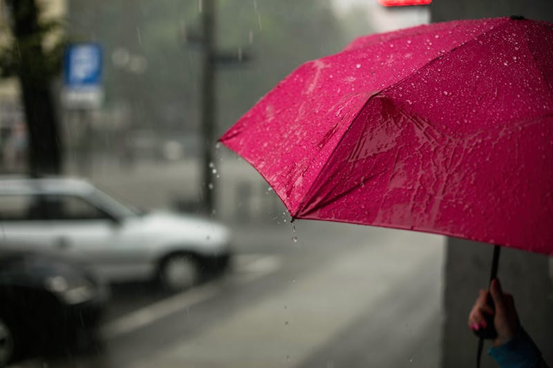 A red umbrella in the rain.