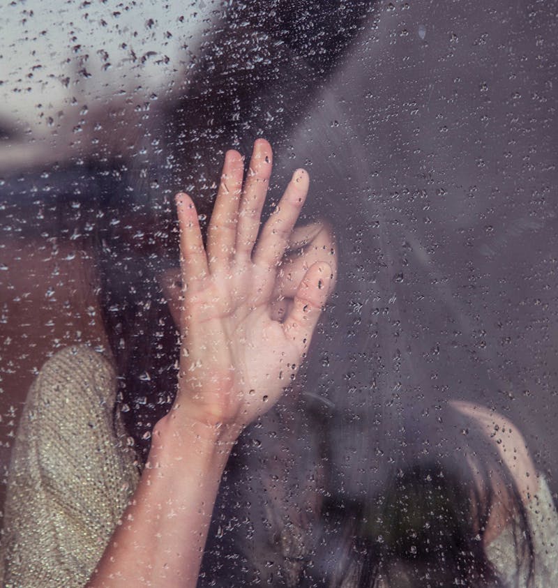 Upset girl in window.