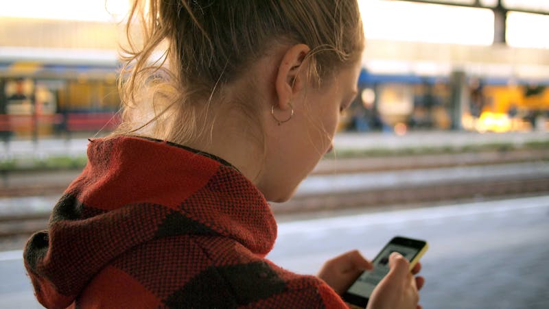 A young girl using her cell phone